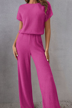 a woman wearing a pink knitted jumpsuit