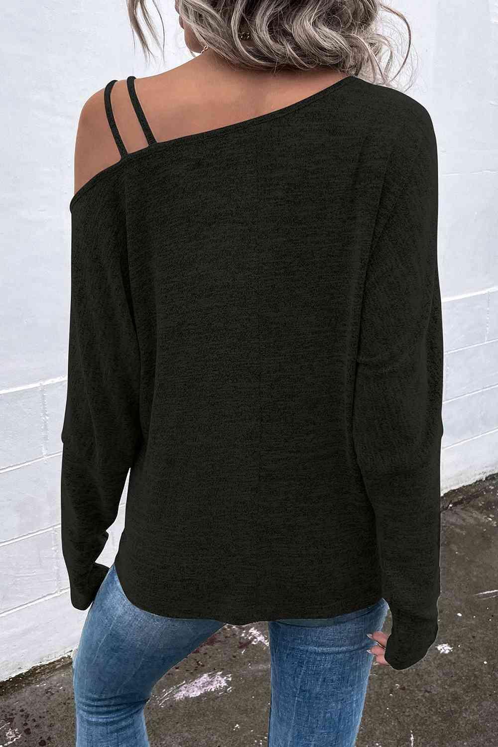 a woman wearing a black sweater and jeans