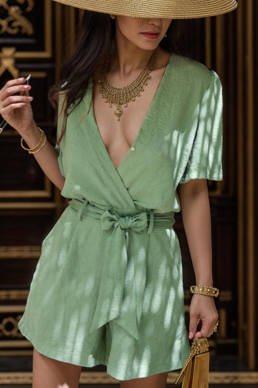 a woman in a green dress and a straw hat