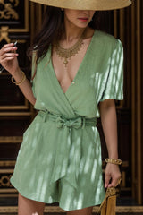 a woman in a green dress and a straw hat