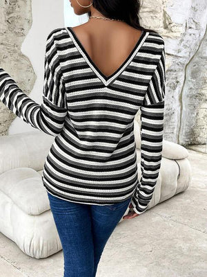 a woman wearing a black and white striped top