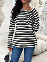 a woman wearing a black and white striped sweater