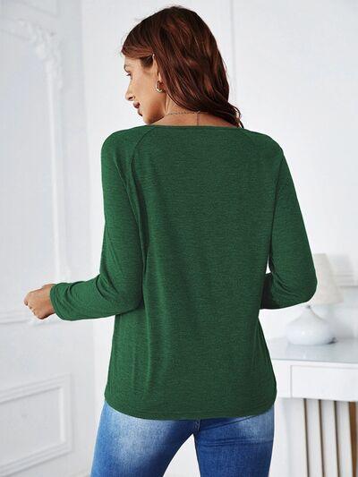 a woman wearing a green sweater and jeans