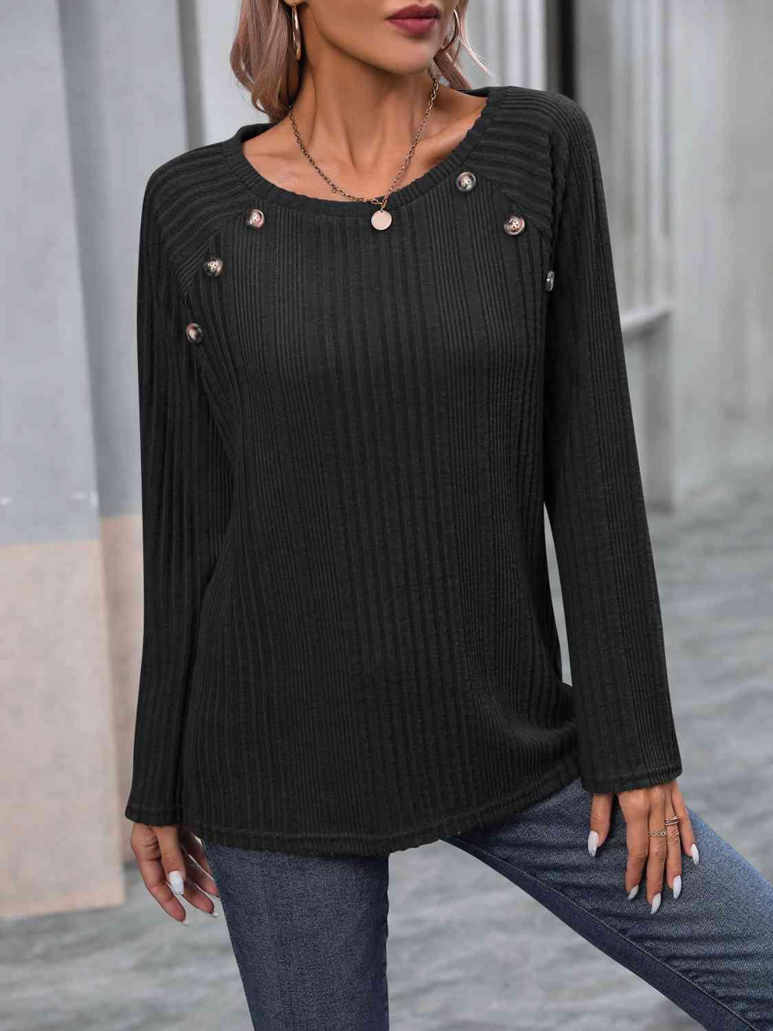 a woman wearing a black sweater and jeans