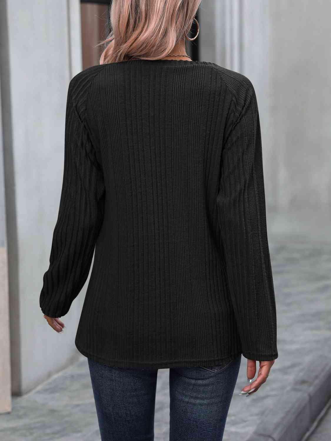 a woman wearing a black sweater and jeans