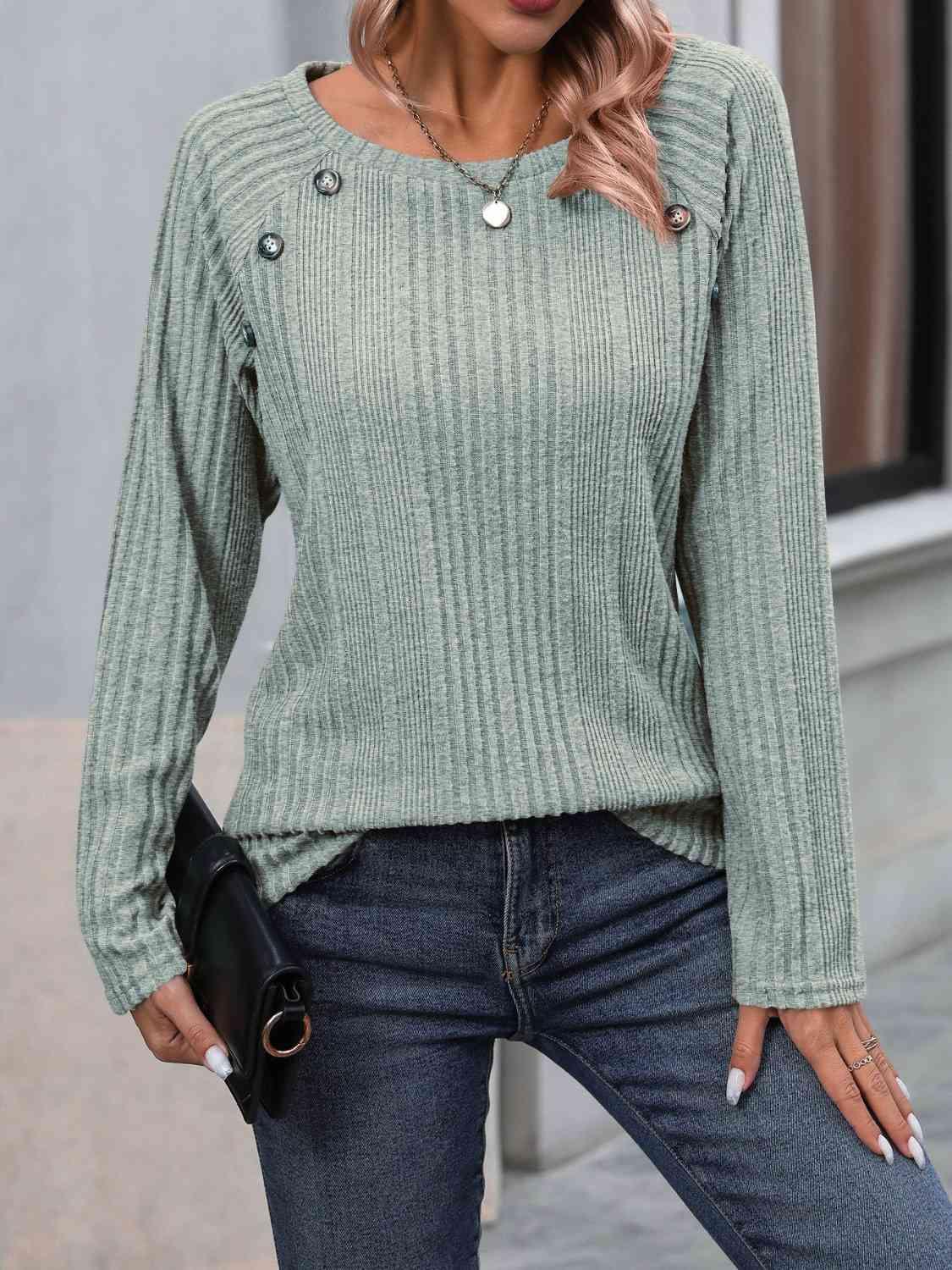 a woman wearing a green sweater and jeans