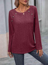 a woman wearing a red sweater and jeans