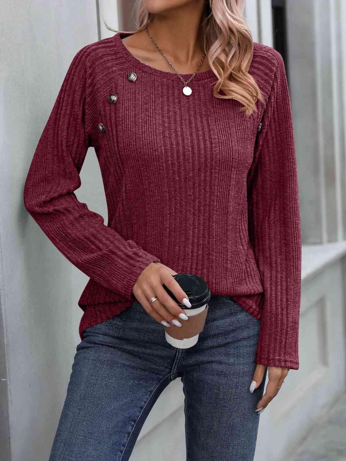 a woman wearing a red sweater and jeans