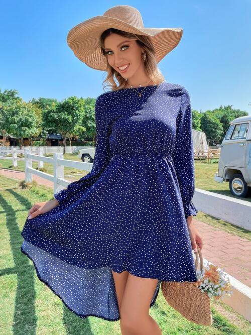 a woman in a blue dress and hat posing for a picture