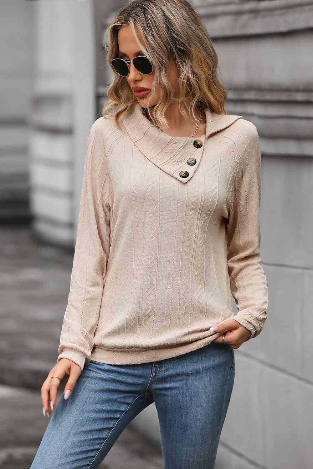 a woman wearing a beige sweater and jeans