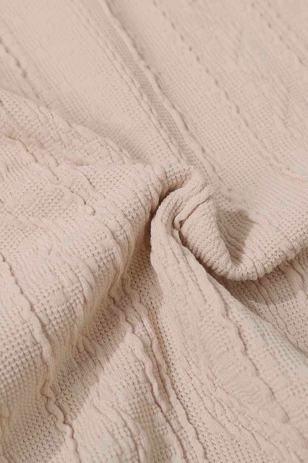 a close up of a white knitted blanket