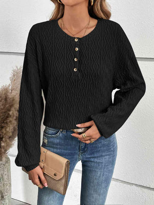 a woman wearing a black top and jeans