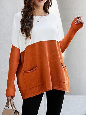 a woman wearing an orange and white sweater