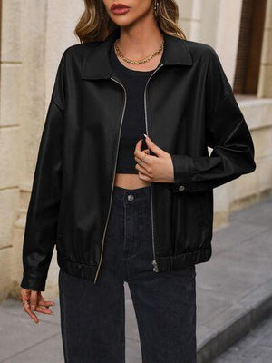 a woman wearing a black jacket and jeans