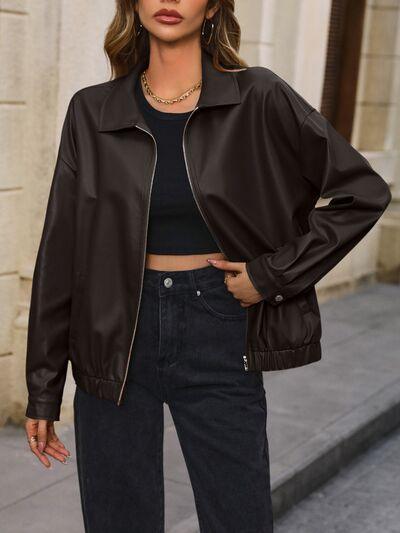 a woman wearing a black leather jacket and jeans