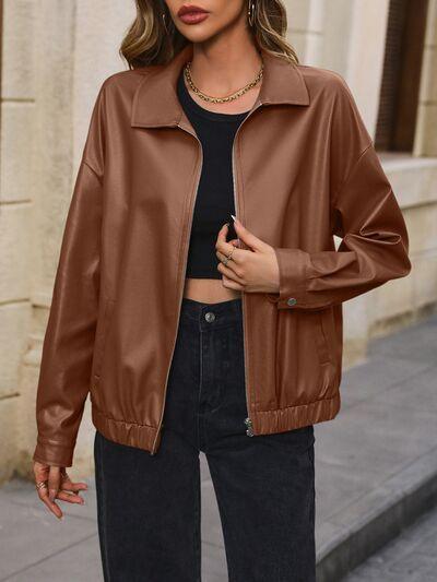 a woman wearing a brown leather jacket and jeans