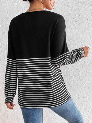 a woman wearing a black and white striped sweater