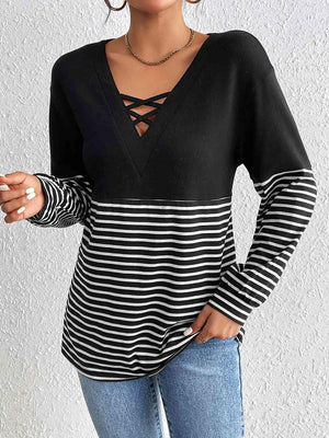 a woman wearing a black and white striped top