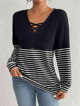 a woman wearing a black and white striped top