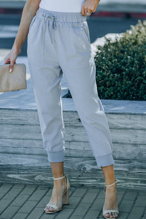 a woman in a white shirt and blue pants