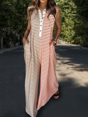 a woman standing on a street wearing a striped jumpsuit