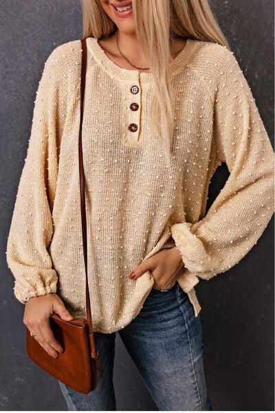 a woman with blonde hair wearing a sweater and jeans