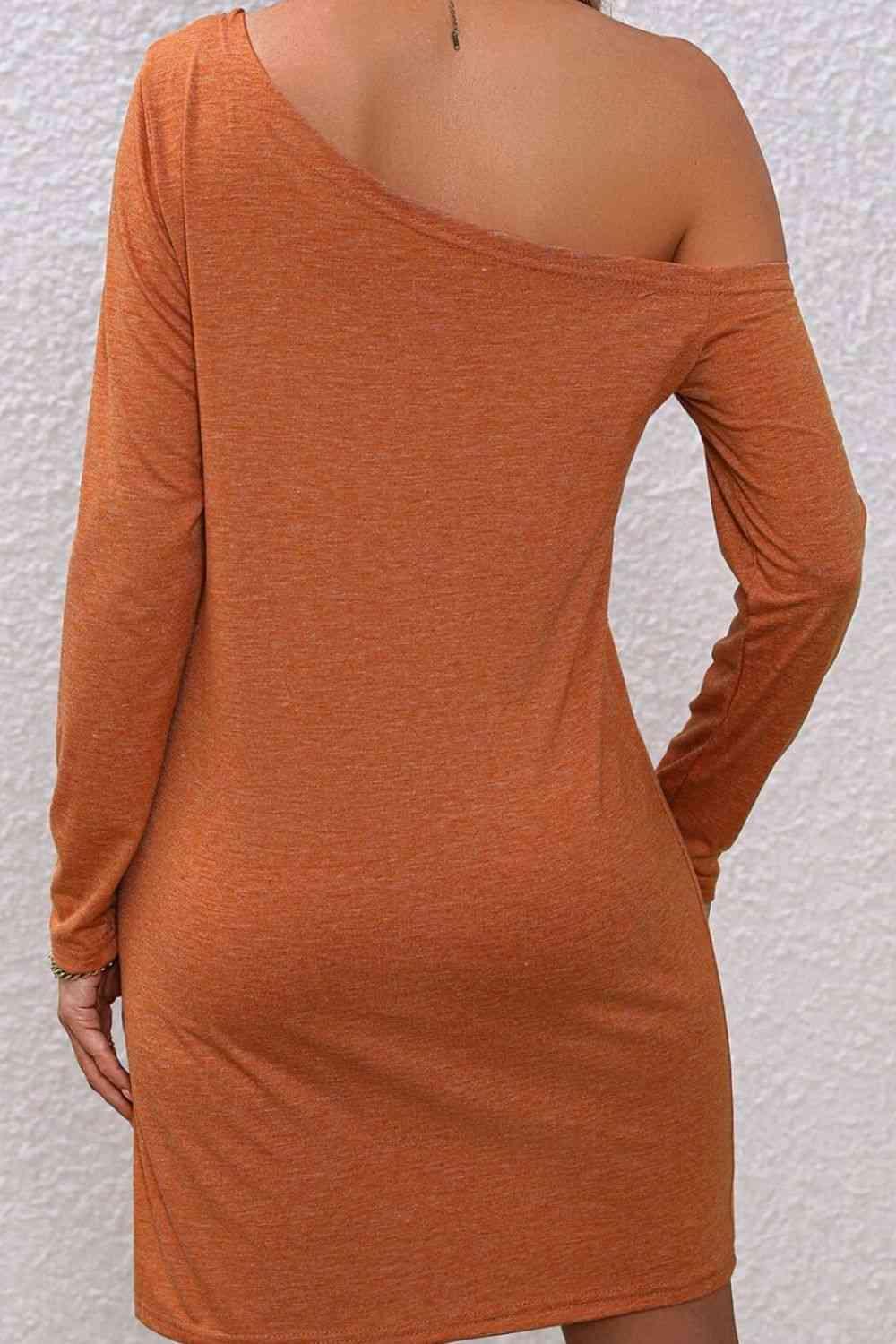 the back of a woman's body wearing an orange dress