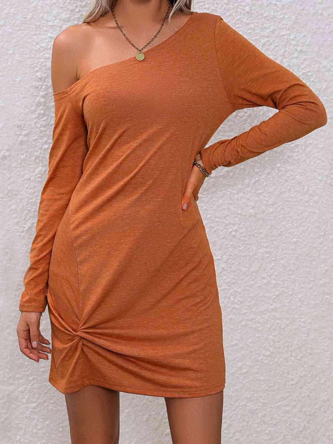 a woman in an orange dress posing for a picture