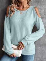 a woman wearing a blue sweater and jeans