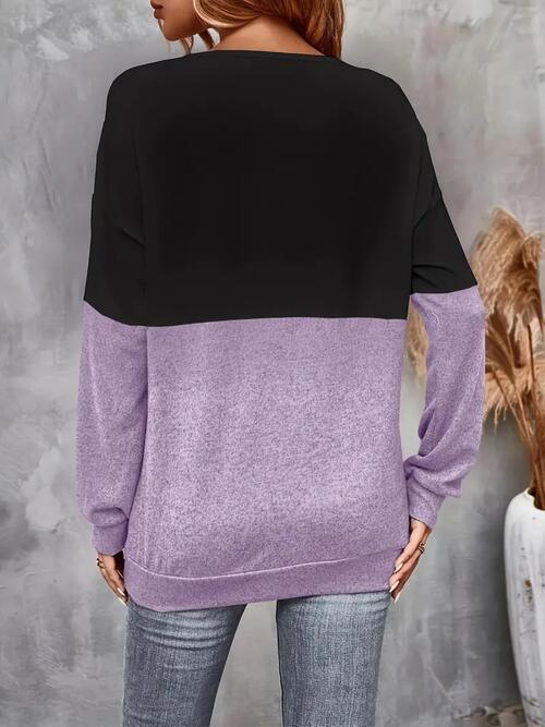 a woman wearing a purple and black sweater