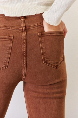 a close up of a person wearing brown pants