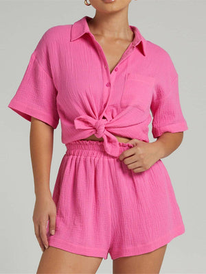 a woman wearing a pink shirt and shorts