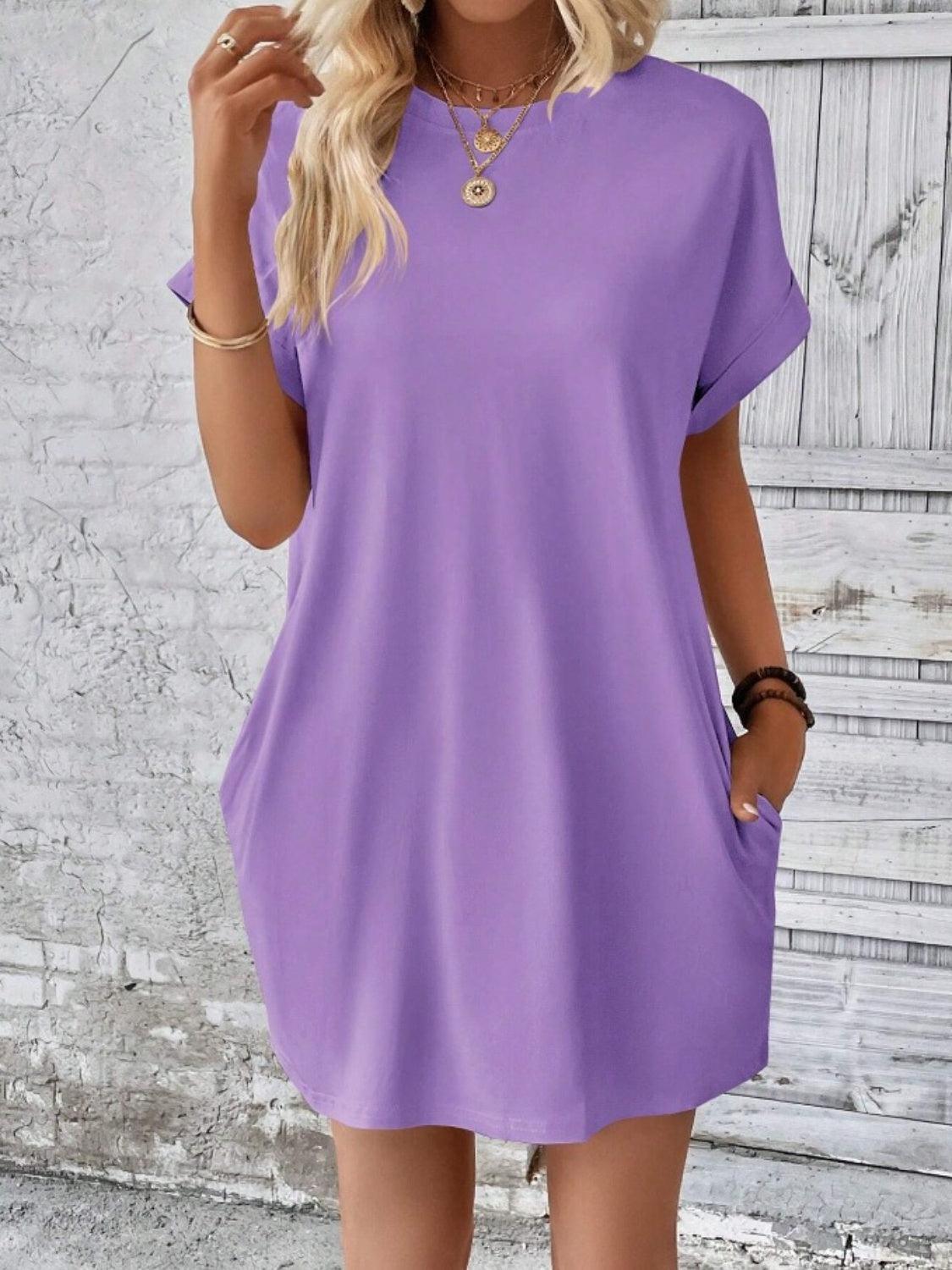 a woman wearing a purple shirt dress