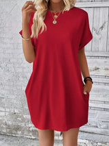 a woman wearing a red shirt dress