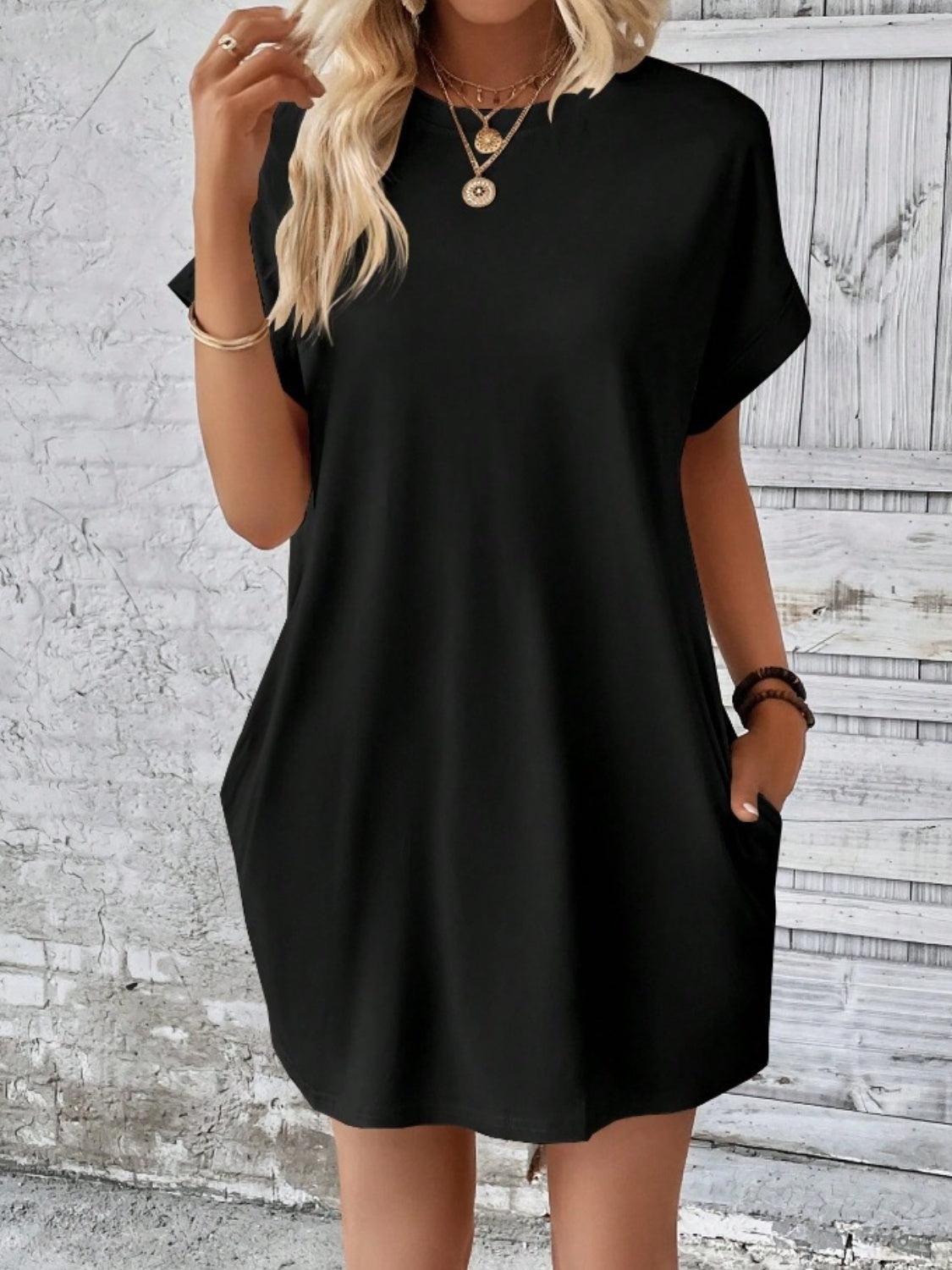 a woman wearing a black shirt dress