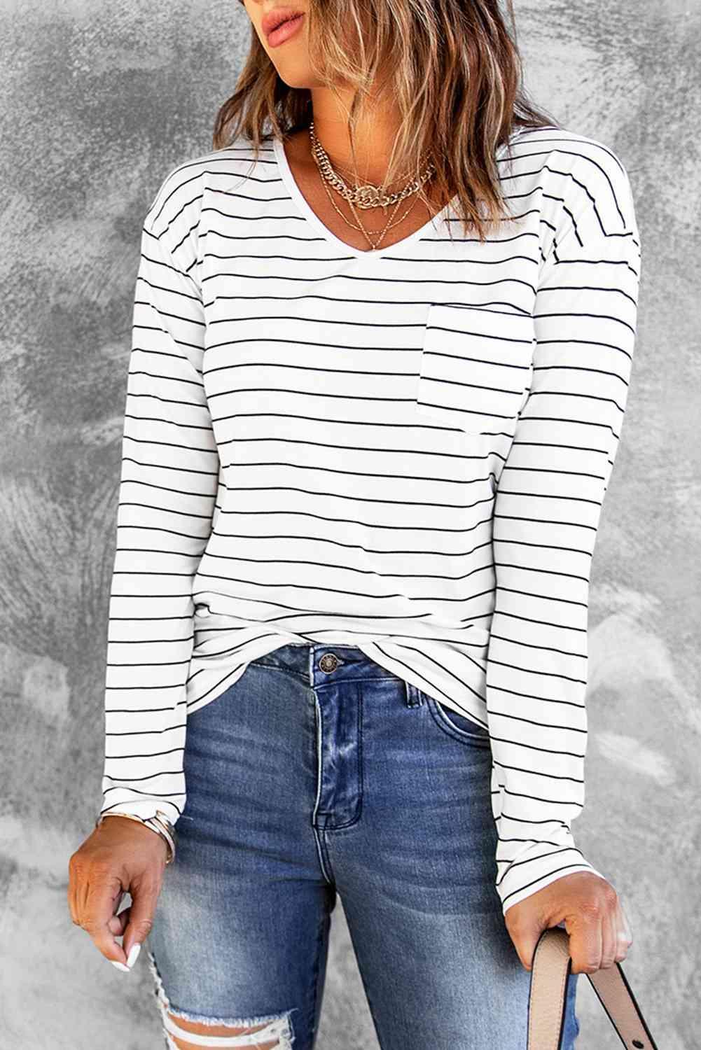 a woman wearing ripped jeans and a striped top