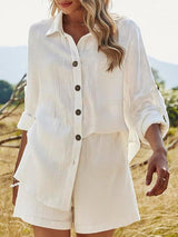 a woman wearing a white shirt and shorts