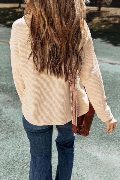 a woman walking down a street holding a purse