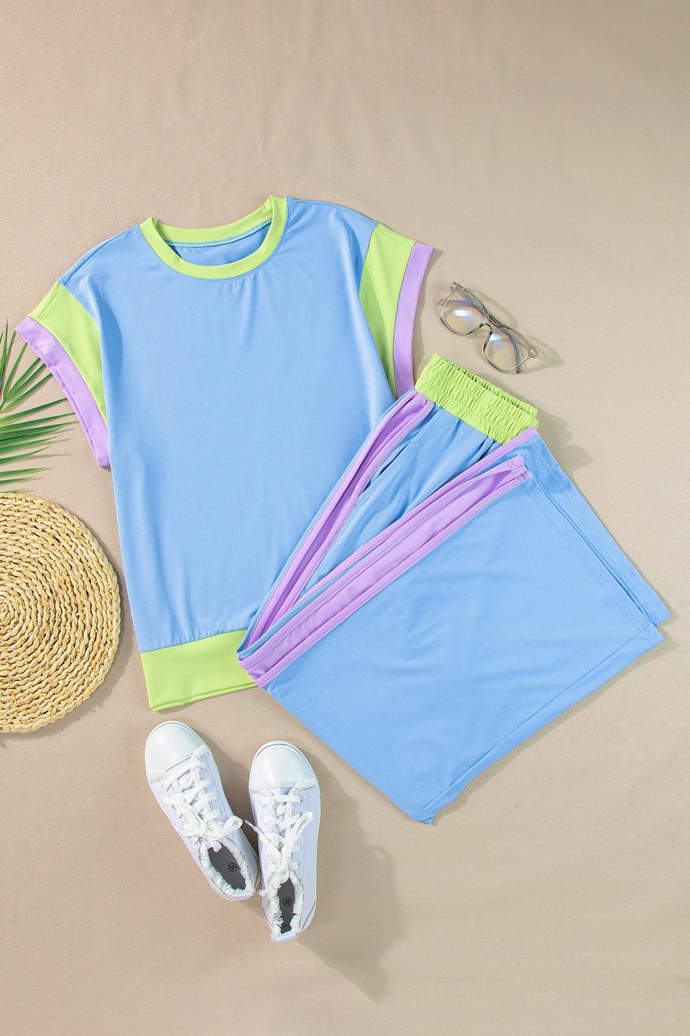 a pair of sunglasses, a straw hat, and a t - shirt laid out