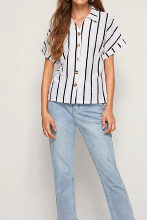 a woman wearing a striped shirt and jeans
