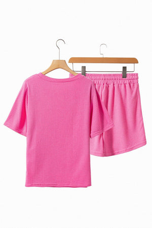 a pair of pink shorts hanging on a clothes rack