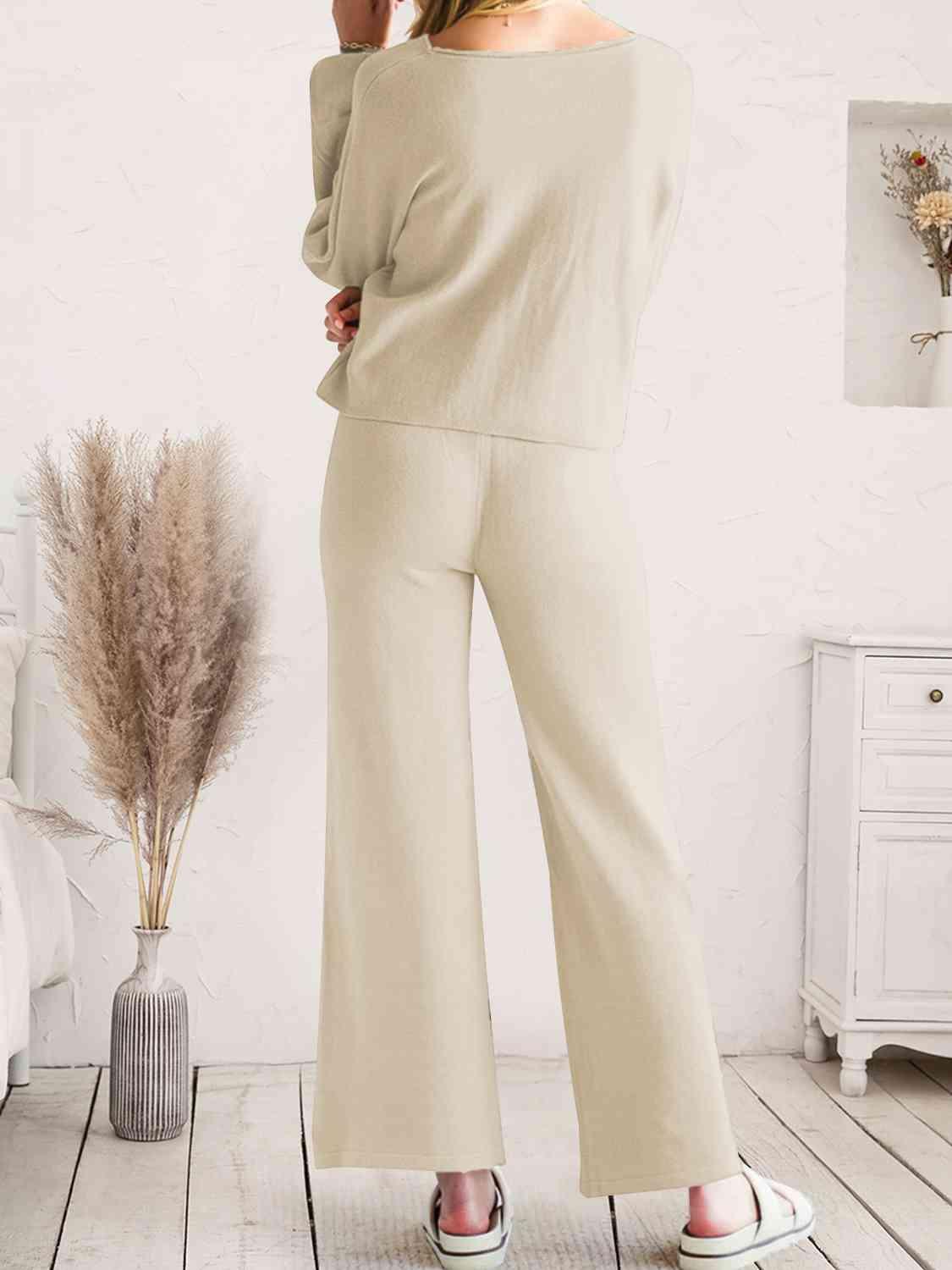 a woman in a white top and beige pants