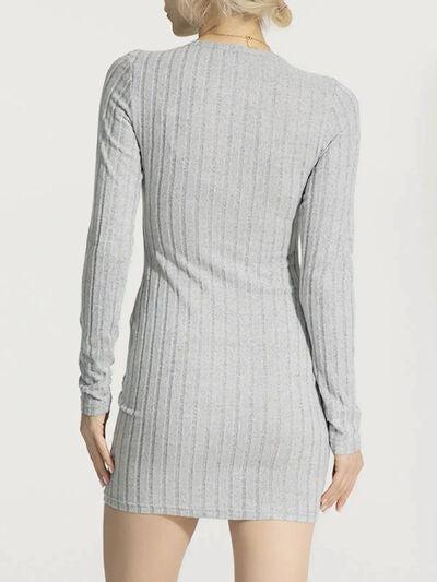 a woman is wearing a gray sweater dress