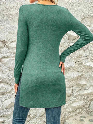 a woman wearing a green sweater and jeans