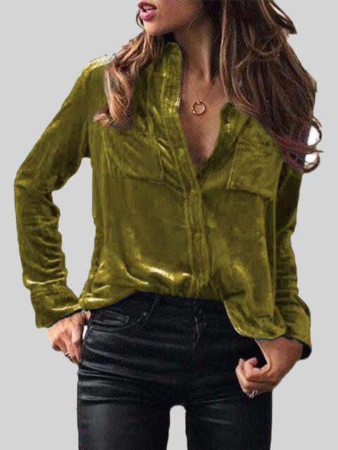 a woman wearing a green shirt and black pants