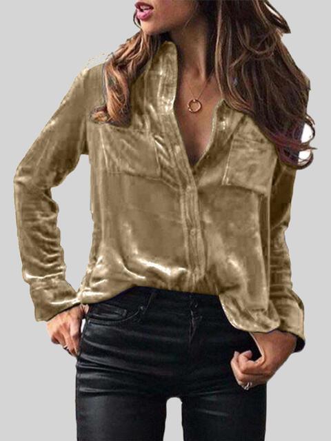 a woman wearing a gold shirt and black pants