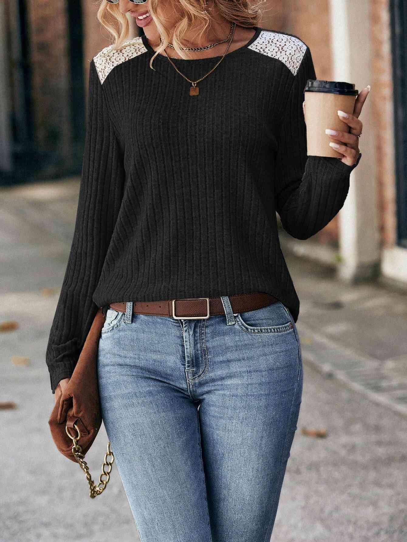 a woman walking down a street holding a cup of coffee