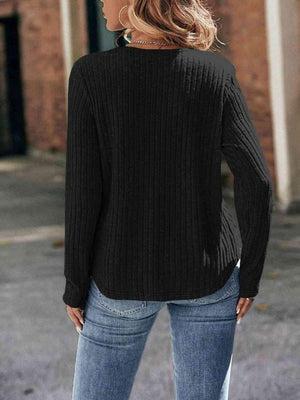 a woman wearing a black sweater and jeans