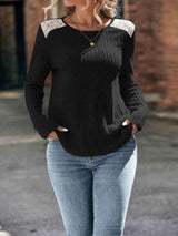 a woman wearing a black sweater and jeans