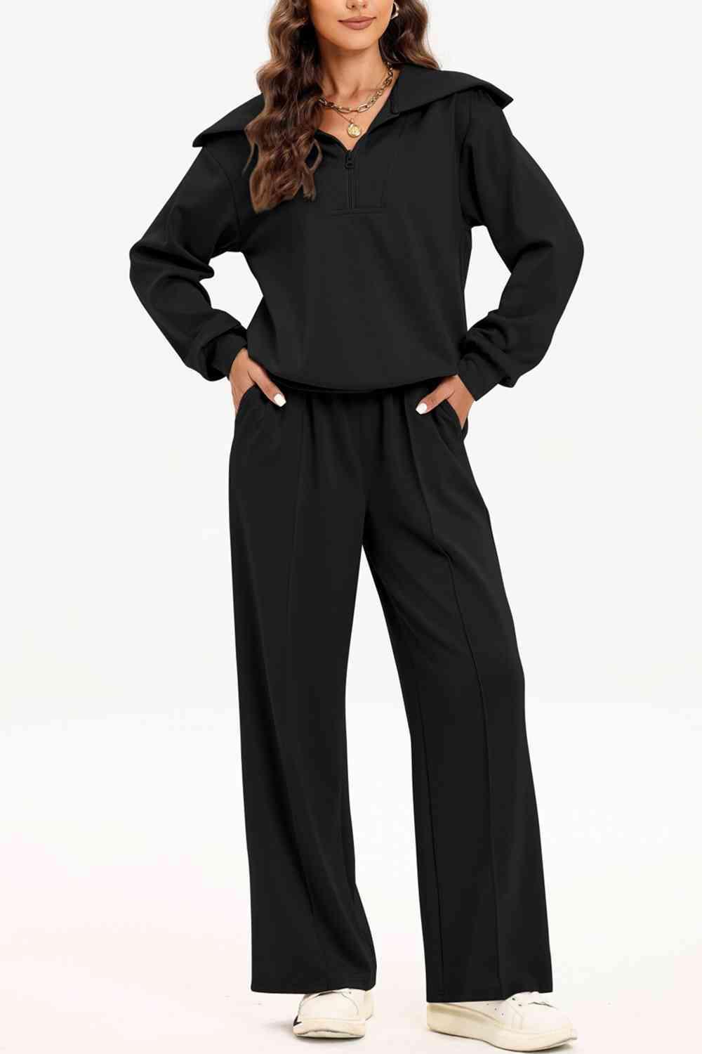 a woman wearing a black jumpsuit and white shoes